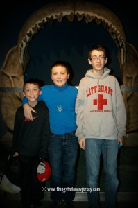 My boys about to be "eaten" by a megalodon at the Adventure Aquarium in Camden, New Jersey | find out more at www.thingstodonewjersey.com | #nj #newjersey #camden #adventureaquarium #aquarium #thingstodo #daytrips #fieldtrips #kids #familyfriendly #fun #educational #rainyday